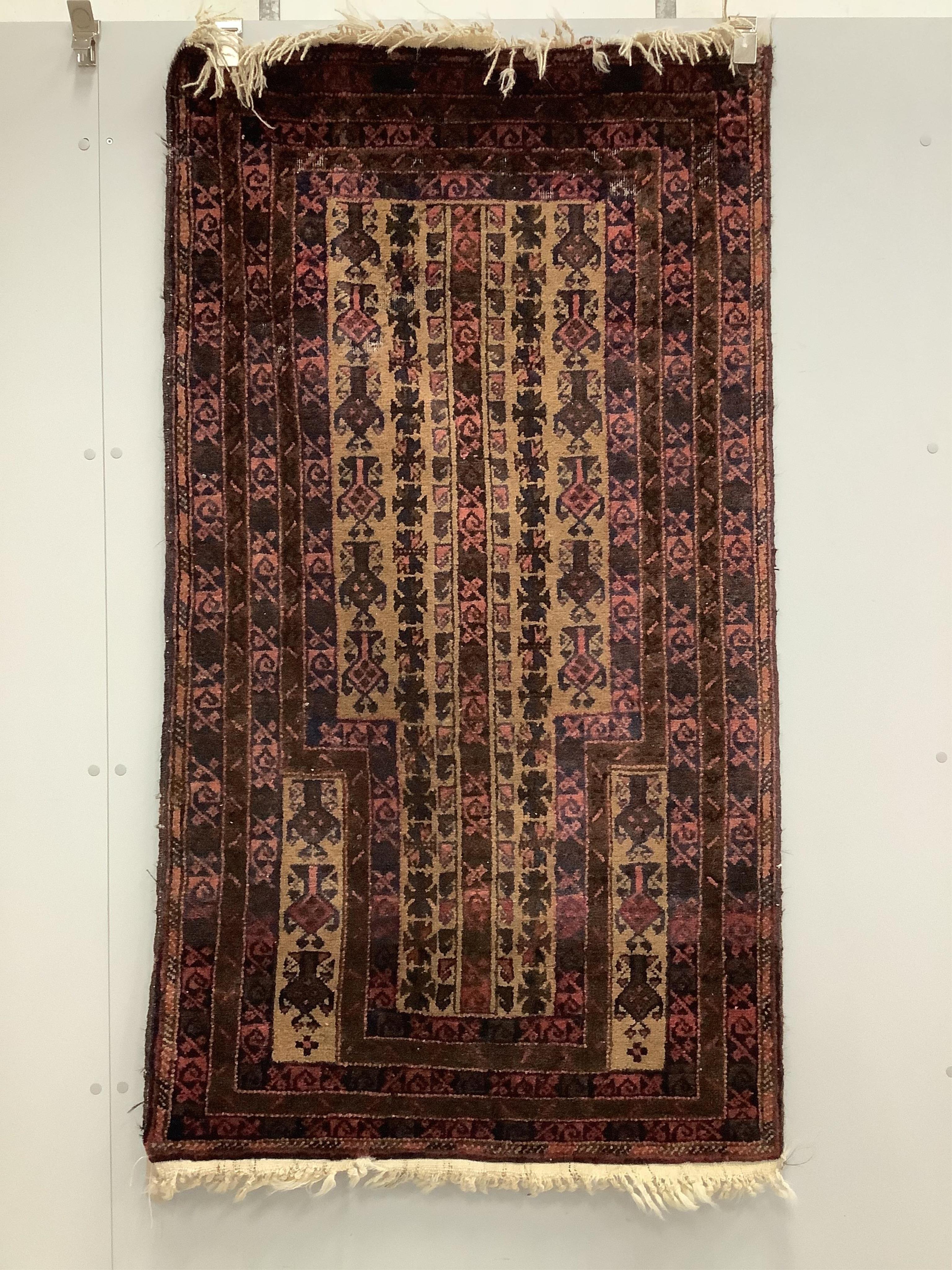 A Belouch fawn ground prayer rug, 152cm x 86cm. Condition - fair, areas of low pile